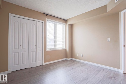 This room features light-colored flooring, neutral-toned walls, and white trim - 201 10909 103 Avenue Nw, Edmonton, AB - Indoor Photo Showing Other Room