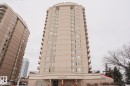 The property is a high-rise building featuring a light-colored facade, numerous windows, and private balconies on each level - 201 10909 103 Avenue Nw, Edmonton, AB  - Outdoor With Facade 
