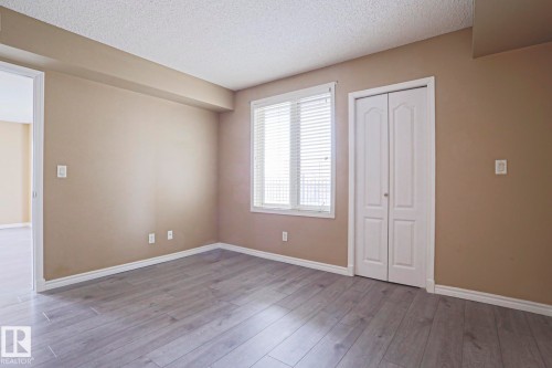 This room features light-colored laminate flooring and a window with blinds - 201 10909 103 Avenue Nw, Edmonton, AB - Indoor Photo Showing Other Room