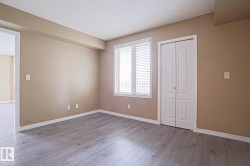 This room features light-colored laminate flooring and a window with blinds - 