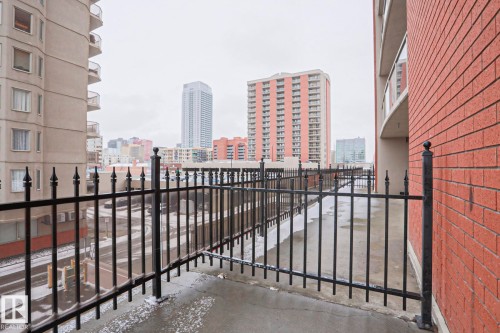 Outdoor balcony space with a black metal railing and a cityscape view - 201 10909 103 Avenue Nw, Edmonton, AB - Outdoor With Exterior