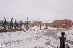 Views of the surrounding neighborhood feature a streetscape with snow-covered roads and trees, alongside commercial buildings - 
