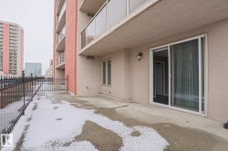 This property features a private outdoor patio with a sliding glass door entry and an exterior wall light fixture - 