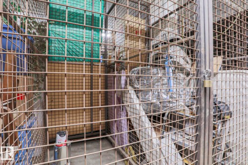 Secure storage unit with a metal mesh construction and concrete floor - 201 10909 103 Avenue Nw, Edmonton, AB - Indoor With Storage