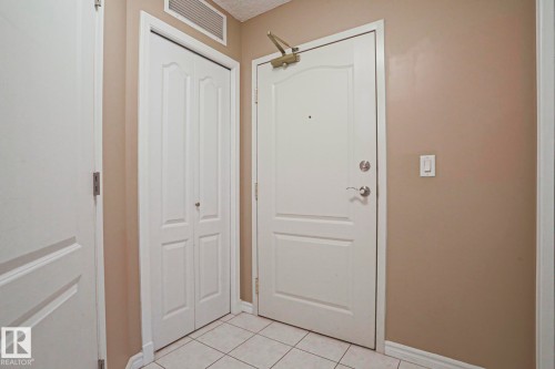 Entryway featuring a white door, a folding closet door, and tiled flooring - 201 10909 103 Avenue Nw, Edmonton, AB - Indoor Photo Showing Other Room