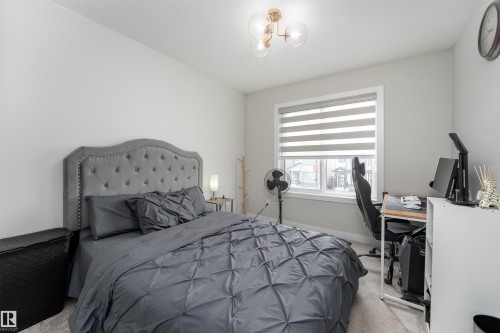 Bedroom with light-colored walls and a window with blinds - 993 Berg Pl, Leduc, AB - Indoor Photo Showing Bedroom