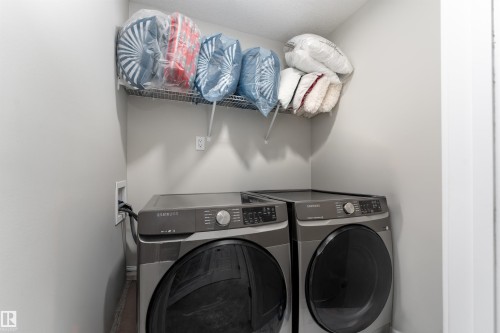 Dedicated laundry area featuring a shelf for storage - 993 Berg Pl, Leduc, AB - Indoor Photo Showing Laundry Room