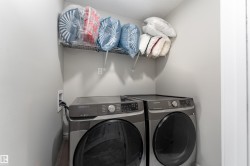 Dedicated laundry area featuring a shelf for storage - 