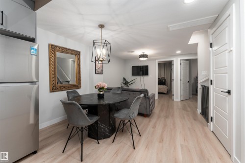 Open-concept living space featuring light-colored flooring, white walls, and recessed lighting - 993 Berg Pl, Leduc, AB - Indoor Photo Showing Dining Room