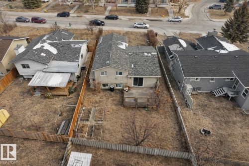 The property features a private fenced yard with a wooden deck and raised garden beds - 2516 42 Street, Edmonton, AB - Outdoor