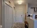 Foyer featuring a flush-mount ceiling light, white paneled doors, and direct access to the kitchen with white cabinetry and a subway tile backsplash - 304 5201 Brougham Drive, Drayton Valley, AB  - Indoor Photo Showing Other Room 
