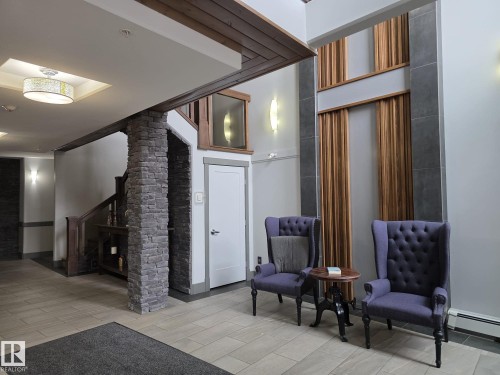Entryway featuring stone pillars, wood accents, and tiled flooring - 304 5201 Brougham Drive, Drayton Valley, AB - Indoor Photo Showing Other Room