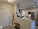 Kitchen featuring white cabinetry, stainless steel appliances, a subway tile backsplash, and granite countertops - 304 5201 Brougham Drive, Drayton Valley, AB  - Indoor Photo Showing Kitchen 