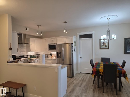 The kitchen features white cabinetry, stainless steel appliances, and a subway tile backsplash - 304 5201 Brougham Drive, Drayton Valley, AB - Indoor