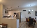 The kitchen features white cabinetry, stainless steel appliances, and a subway tile backsplash - 304 5201 Brougham Drive, Drayton Valley, AB  - Indoor 