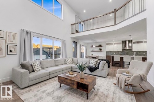 The property features a spacious open-concept living area with high ceilings and large windows, providing natural light - 1407 Graydon Hill Way, Edmonton, AB - Indoor Photo Showing Living Room