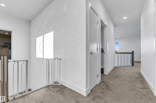 The property features a hallway with carpeted flooring and white walls - 1407 Graydon Hill Way, Edmonton, AB - Indoor Photo Showing Other Room
