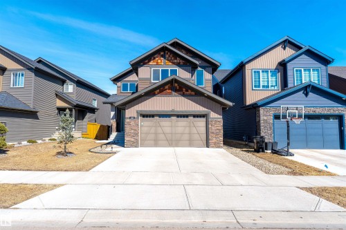The property features a two-story design with a concrete driveway and an attached two-car garage - 1407 Graydon Hill Way, Edmonton, AB - Outdoor