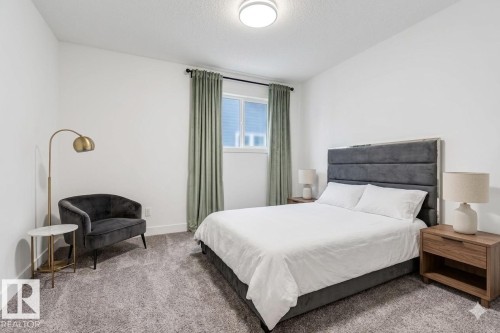 This room features white walls, a window with green curtains, and carpeted flooring - 1407 Graydon Hill Way, Edmonton, AB - Indoor Photo Showing Bedroom