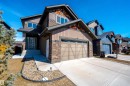 The property features a two-story design with a prominent front entrance, an attached garage, and stone accent cladding - 1407 Graydon Hill Way, Edmonton, AB  - Outdoor 