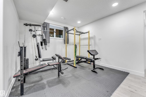 Dedicated fitness area featuring white walls, recessed lighting, and a window with blinds - 1407 Graydon Hill Way, Edmonton, AB - Indoor Photo Showing Gym Room