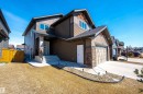 The property features a two-story exterior with dark brown siding and stone accents - 1407 Graydon Hill Way, Edmonton, AB  - Outdoor 