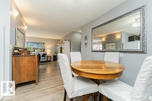 Dining area featuring a circular wood table and light-toned flooring - 8 Duke Drive, Lamont, AB - Indoor Photo Showing Dining Room
