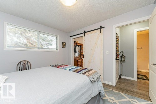 This room features light-colored walls and a window with blinds providing natural light - 8 Duke Drive, Lamont, AB - Indoor Photo Showing Bedroom