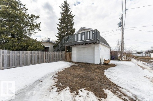 Detached garage with a second-story deck featuring a railing and an external staircase - 8 Duke Drive, Lamont, AB - Outdoor