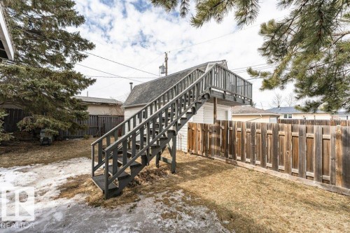The property features a fenced yard with a staircase leading to a raised deck area - 8 Duke Drive, Lamont, AB - Outdoor