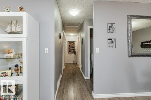 Hallway featuring wood-style flooring and light grey walls - 8 Duke Drive, Lamont, AB - Indoor Photo Showing Other Room