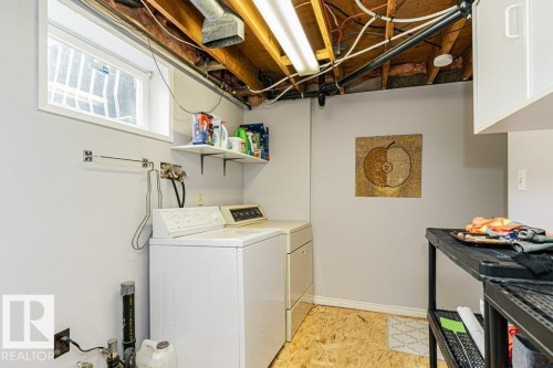 The property features a dedicated laundry area with a washer and dryer, a window, and shelving for storage - 8 Duke Drive, Lamont, AB - Indoor Photo Showing Laundry Room