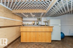 This versatile space features a lattice ceiling, paneled walls, and built-in shelving - 