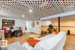 This versatile space features a unique lattice-patterned ceiling, light-colored walls, and a warm-toned parquet floor - 