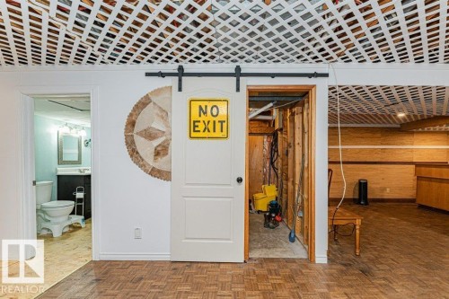 This space features parquet wood flooring and a distinctive lattice ceiling - 8 Duke Drive, Lamont, AB - Indoor Photo Showing Other Room