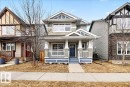 The property features a charming exterior with light grey siding, a covered front porch with white railings, and a blue front door - 1530 Chapman Way, Edmonton, AB  - Outdoor With Deck Patio Veranda With Facade 