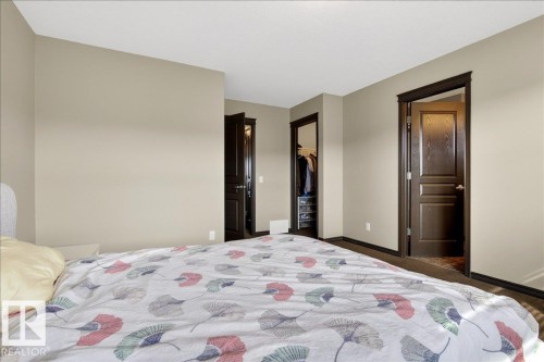 Bedroom featuring neutral-toned walls, dark trim, and dark doors - 1530 Chapman Way, Edmonton, AB - Indoor Photo Showing Bedroom