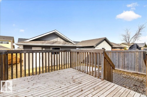 The property features a wood deck with railings, providing an elevated outdoor living space - 1530 Chapman Way, Edmonton, AB - Outdoor With Deck Patio Veranda With Exterior