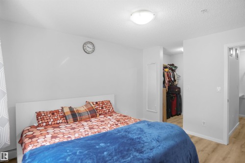 Bedroom featuring light-colored walls and a ceiling light fixture - 103 3353 16A Avenue, Edmonton, AB - Indoor Photo Showing Bedroom