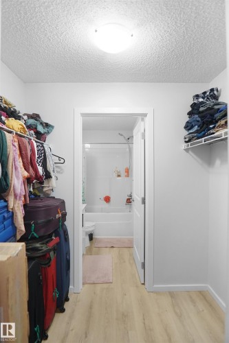 This area features light-toned flooring and white walls, with a ceiling-mounted light fixture - 103 3353 16A Avenue, Edmonton, AB - Indoor With Storage