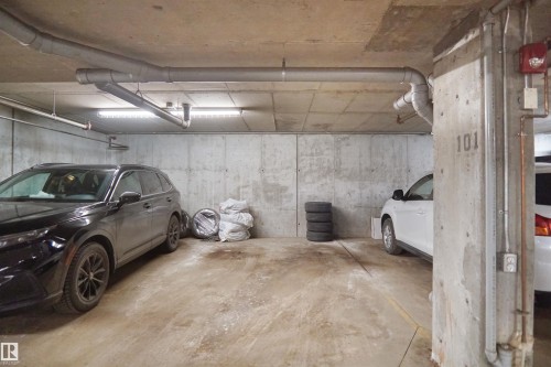 Parking space with concrete walls and ceiling - 103 3353 16A Avenue, Edmonton, AB - Indoor Photo Showing Garage