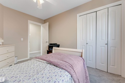 This room features neutral-toned walls, carpeted flooring, and a ceiling fan - 121 64 Street, Edmonton, AB - Indoor Photo Showing Bedroom