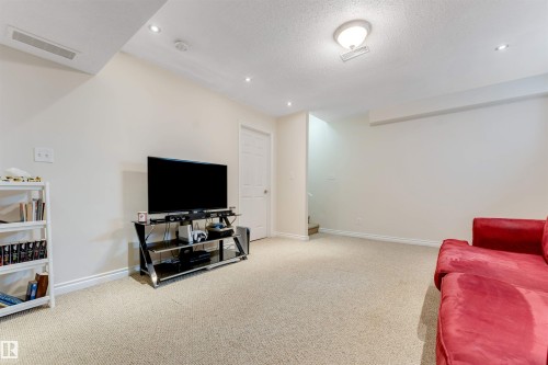 Spacious room with light-colored carpeting, recessed lighting, and a neutral wall color - 121 64 Street, Edmonton, AB - Indoor