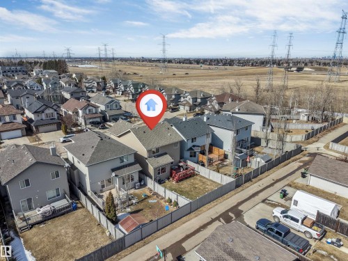 Aerial view of the property, showcasing the rear exterior with a deck and fenced yard - 121 64 Street, Edmonton, AB - Outdoor With View