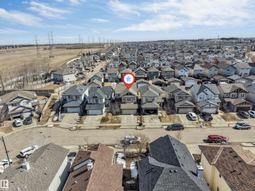 Aerial view of the property with a two-car garage, located within a residential community featuring diverse housing styles - 121 64 Street, Edmonton, AB - Outdoor With View
