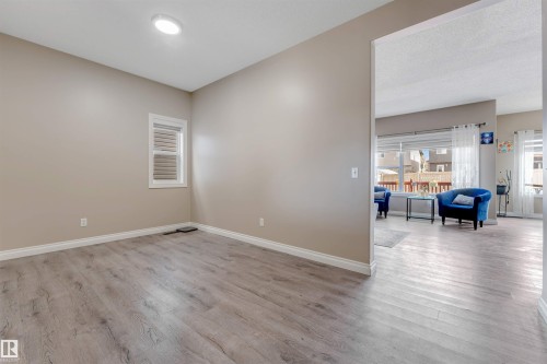 This versatile room features light-colored walls, a window with blinds, and recessed lighting - 121 64 Street, Edmonton, AB - Indoor Photo Showing Other Room