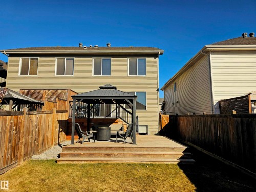 The property features a fenced yard with a lawn, a wooden deck, and a gazebo - 6888 Evans Wynd, Edmonton, AB - Outdoor With Deck Patio Veranda With Exterior