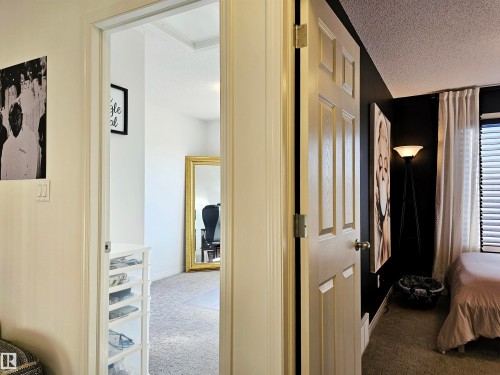 The property features interior doors with paneling and a carpeted floor - 6888 Evans Wynd, Edmonton, AB - Indoor