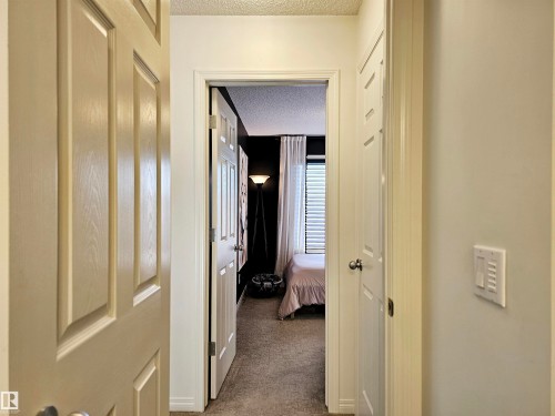 Hallway with light colored walls and carpeted flooring - 6888 Evans Wynd, Edmonton, AB - Indoor Photo Showing Other Room