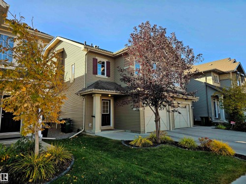 The property features a two-story exterior with horizontal siding, a covered entry, and a two-car garage - 6888 Evans Wynd, Edmonton, AB - Outdoor